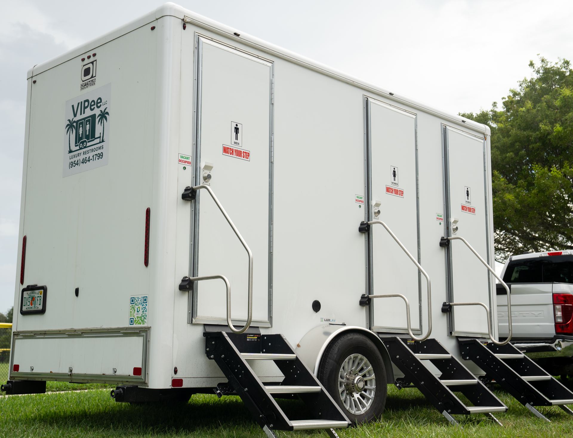 VIPee restroom trailer with branded signage on-site