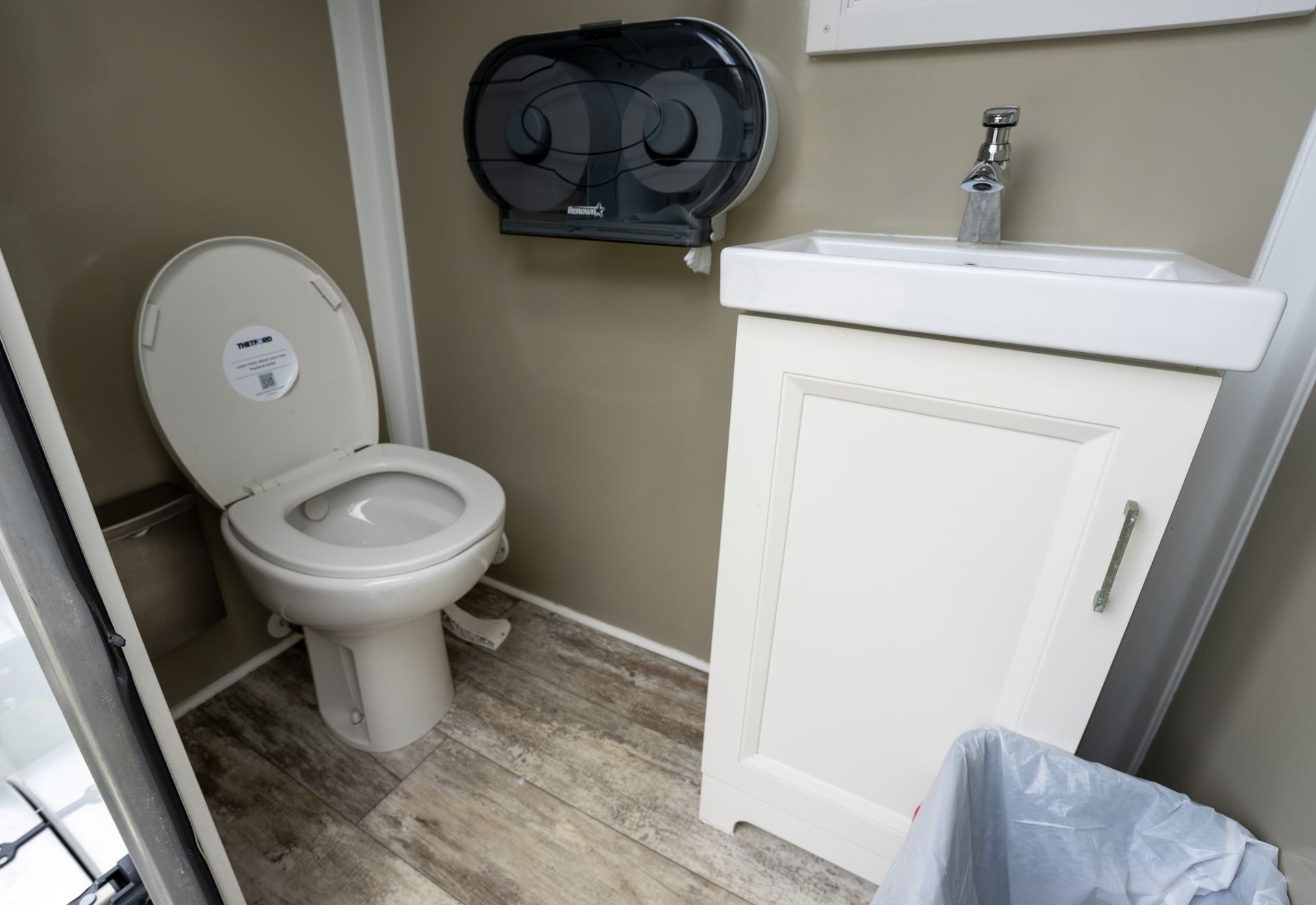 Clean, well-lit interior of VIPee restroom trailer