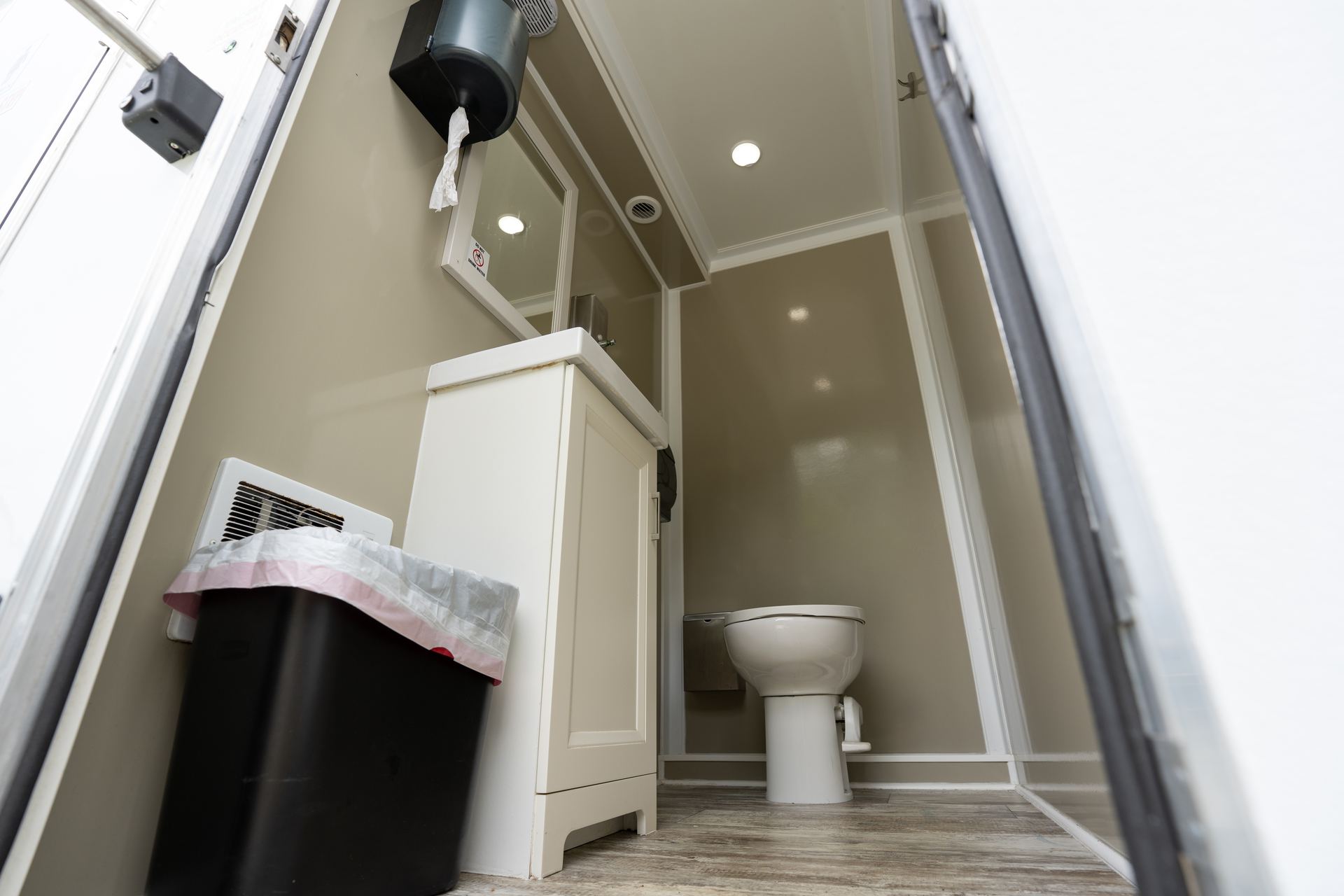 Restroom stall door and fixtures inside VIPee trailer